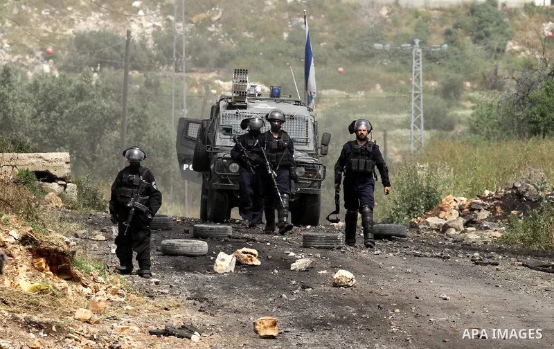 Israeli security forces take aim during clashes with Palestinian protesters following a weekly demonstration against the expropriation of Palestinian land by Israel in the village of Kfar Qaddum, near Nablus, in the occu...
