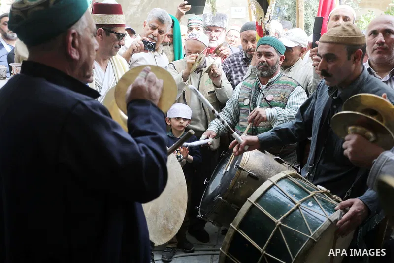 Palestinians perform during a festival at the mosque of Nabi Musa, where the tomb of Prophet Moses is believed to be placed, in the Judean Desert neat the West Bank town of Jericho, on April 8, 2016. The festival sponsor...