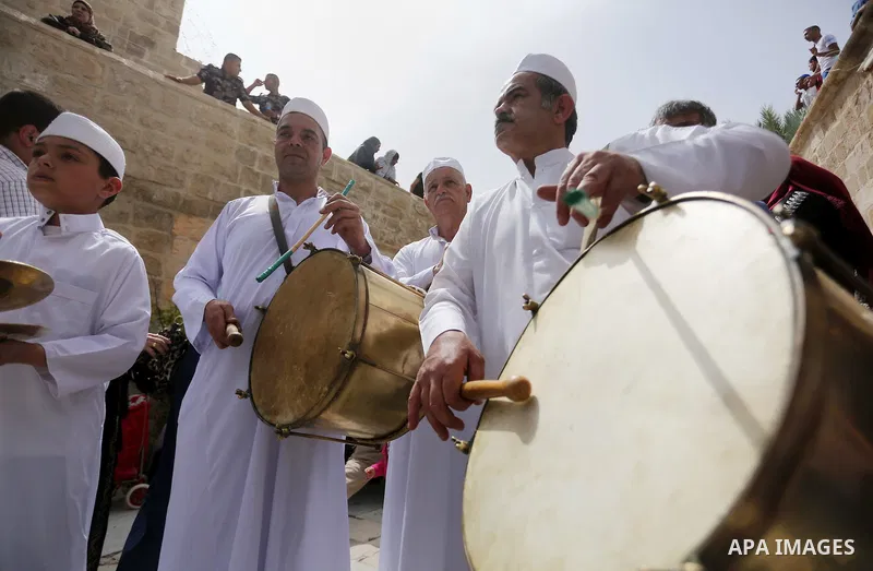 Palestinians perform during a festival at the mosque of Nabi Musa, where the tomb of Prophet Moses is believed to be placed, in the Judean Desert neat the West Bank town of Jericho, on April 8, 2016. The festival sponsor...
