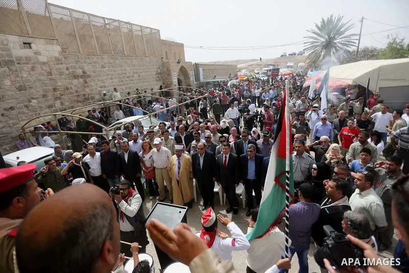 Palestinians attend a festival at the mosque of Nabi Musa, where the tomb of Prophet Moses is believed to be placed, in the Judean Desert neat the West Bank town of Jericho, on April 8, 2016. The festival sponsored by th...