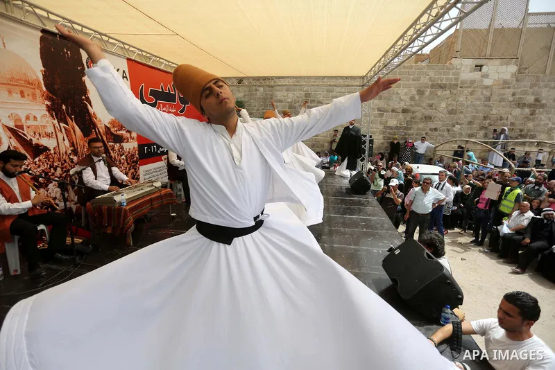 Whirling dervishes perform during a festival at the mosque of Nabi Musa, where the tomb of Prophet Moses is believed to be placed, in the Judean Desert neat the West Bank town of Jericho, on April 8, 2016. The festival s...