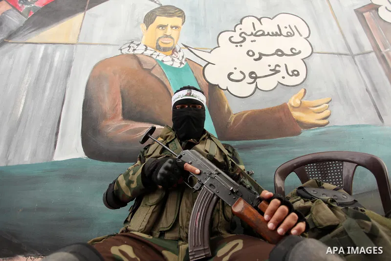 A member of the Ezzedine al-Qassam Brigades, the military wing of the Palestinian Islamist movement Hamas takes part during a protest demanding release the prisoners in Israeli jails at the Erez crossing checkpoint in th...