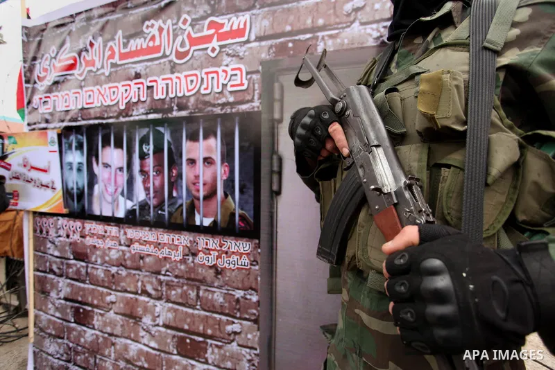 A member of the Ezzedine al-Qassam Brigades, the military wing of the Palestinian Islamist movement Hamas takes part during a protest demanding release the prisoners in Israeli jails at the Erez crossing checkpoint in th...