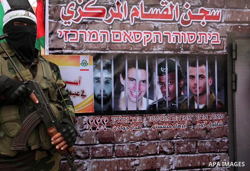 A member of the Ezzedine al-Qassam Brigades, the military wing of the Palestinian Islamist movement Hamas takes part during a protest demanding release the prisoners in Israeli jails at the Erez crossing checkpoint in th...