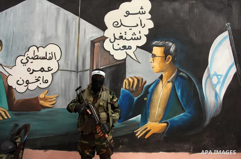 A member of the Ezzedine al-Qassam Brigades, the military wing of the Palestinian Islamist movement Hamas takes part during a protest demanding release the prisoners in Israeli jails at the Erez crossing checkpoint in th...