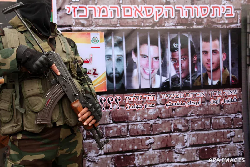 A member of the Ezzedine al-Qassam Brigades, the military wing of the Palestinian Islamist movement Hamas takes part during a protest demanding release the prisoners in Israeli jails at the Erez crossing checkpoint in th...