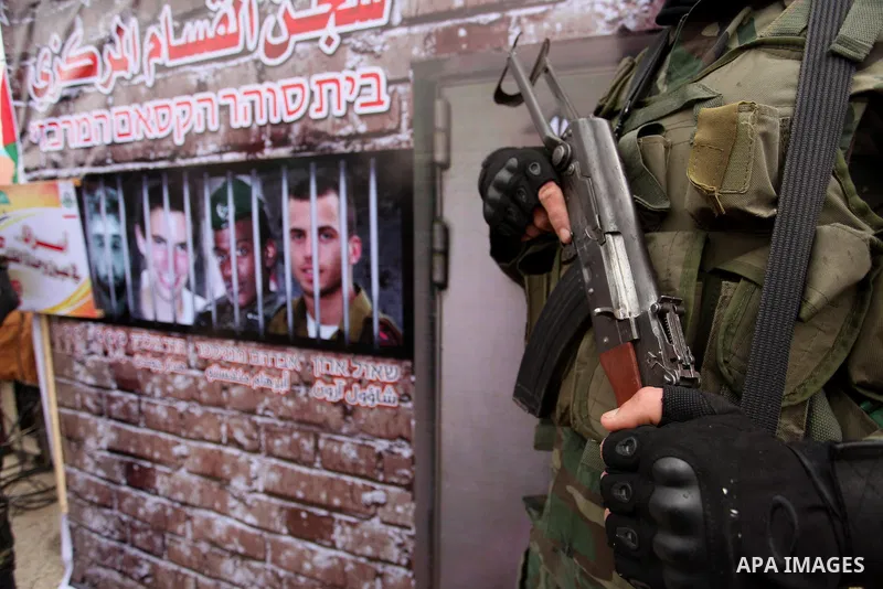 A member of the Ezzedine al-Qassam Brigades, the military wing of the Palestinian Islamist movement Hamas takes part during a protest demanding release the prisoners in Israeli jails at the Erez crossing checkpoint in th...