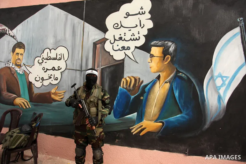 A member of the Ezzedine al-Qassam Brigades, the military wing of the Palestinian Islamist movement Hamas takes part during a protest demanding release the prisoners in Israeli jails at the Erez crossing checkpoint in th...