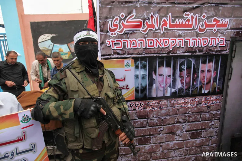 A member of the Ezzedine al-Qassam Brigades, the military wing of the Palestinian Islamist movement Hamas takes part during a protest demanding release the prisoners in Israeli jails at the Erez crossing checkpoint in th...