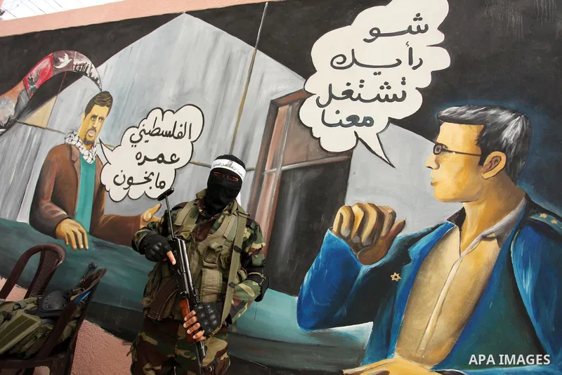 A member of the Ezzedine al-Qassam Brigades, the military wing of the Palestinian Islamist movement Hamas takes part during a protest demanding release the prisoners in Israeli jails at the Erez crossing checkpoint in th...