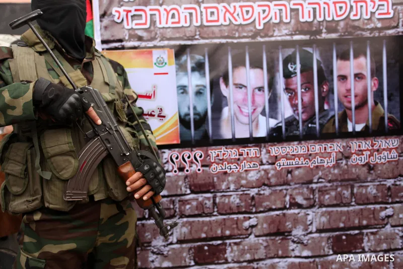 A member of the Ezzedine al-Qassam Brigades, the military wing of the Palestinian Islamist movement Hamas takes part during a protest demanding release the prisoners in Israeli jails at the Erez crossing checkpoint in th...