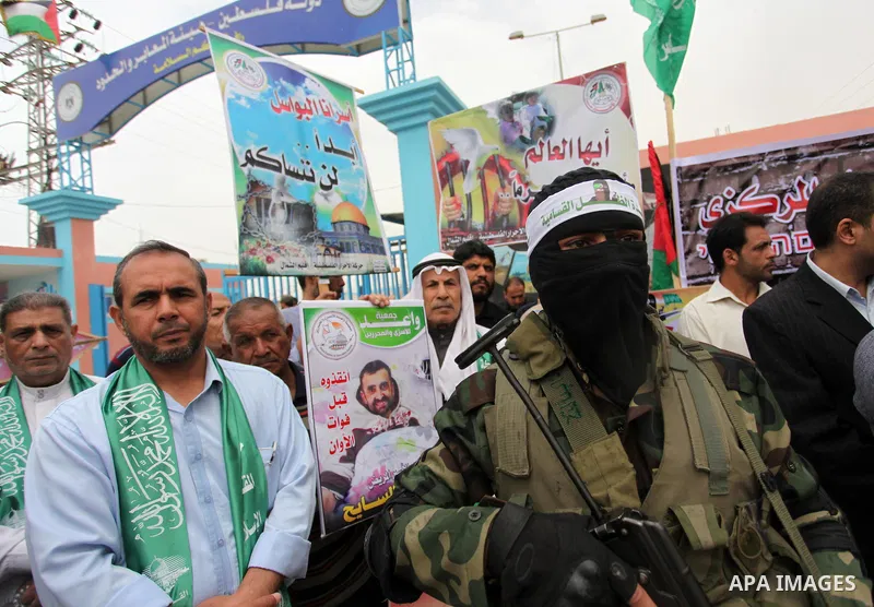 A member of the Ezzedine al-Qassam Brigades, the military wing of the Palestinian Islamist movement Hamas takes part during a protest demanding release the prisoners in Israeli jails at the Erez crossing checkpoint in th...