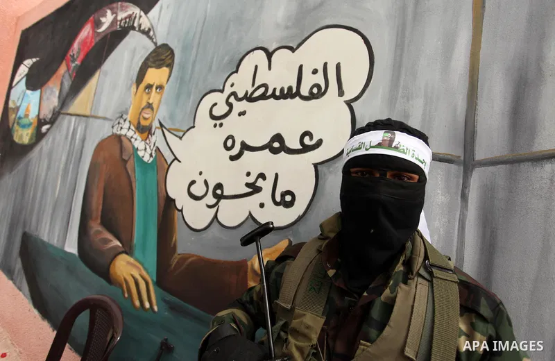 A member of the Ezzedine al-Qassam Brigades, the military wing of the Palestinian Islamist movement Hamas takes part during a protest demanding release the prisoners in Israeli jails at the Erez crossing checkpoint in th...