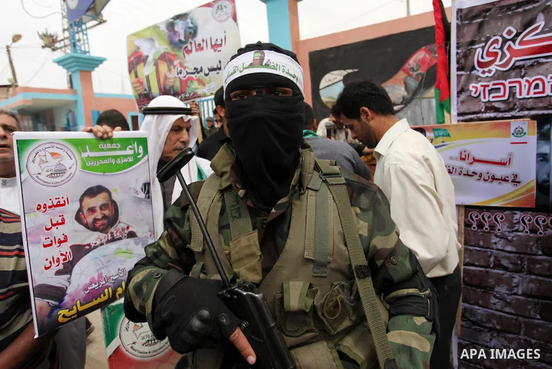 A member of the Ezzedine al-Qassam Brigades, the military wing of the Palestinian Islamist movement Hamas takes part during a protest demanding release the prisoners in Israeli jails at the Erez crossing checkpoint in th...