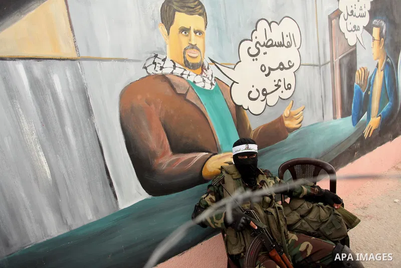 A member of the Ezzedine al-Qassam Brigades, the military wing of the Palestinian Islamist movement Hamas takes part during a protest demanding release the prisoners in Israeli jails at the Erez crossing checkpoint in th...