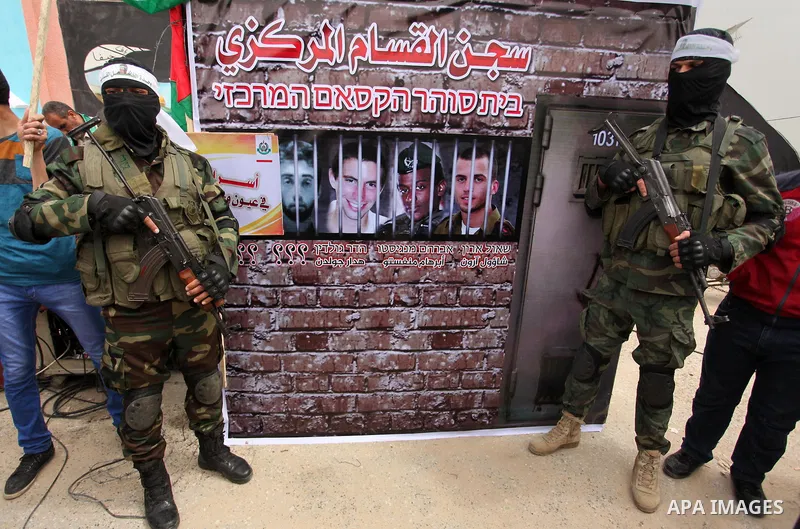 Members of the Ezzedine al-Qassam Brigades, the military wing of the Palestinian Islamist movement Hamas take part during a protest demanding release the prisoners in Israeli jails at the Erez crossing checkpoint in the...