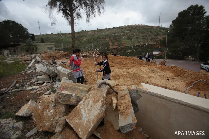 Palestinian children inspect the damage to a children's garden after it was demolished by Israeli troops in the village of Za'tara near the West Bank city of Nablus, Tuesday, April 12, 2016. Israeli forces demolished the...