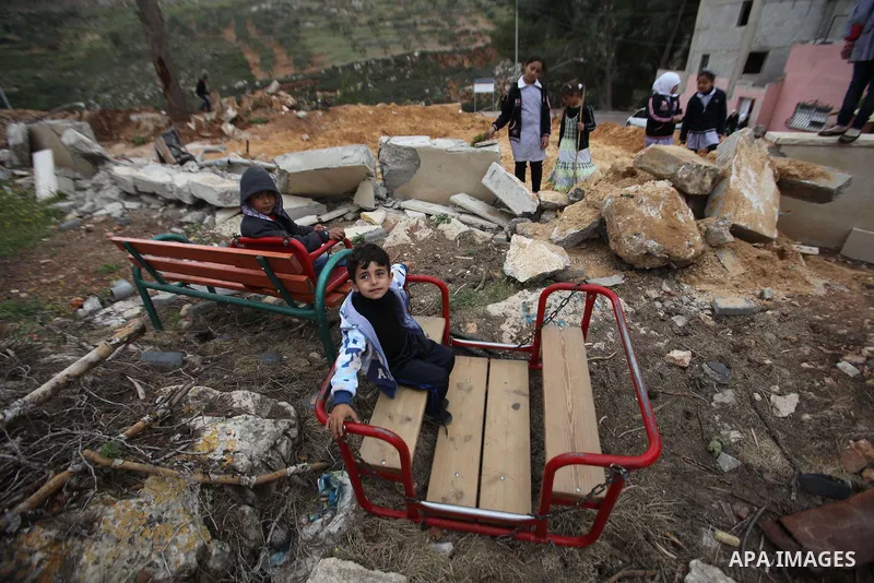 Palestinian children inspect the damage to a children's garden after it was demolished by Israeli troops in the village of Za'tara near the West Bank city of Nablus, Tuesday, April 12, 2016. Israeli forces demolished the...