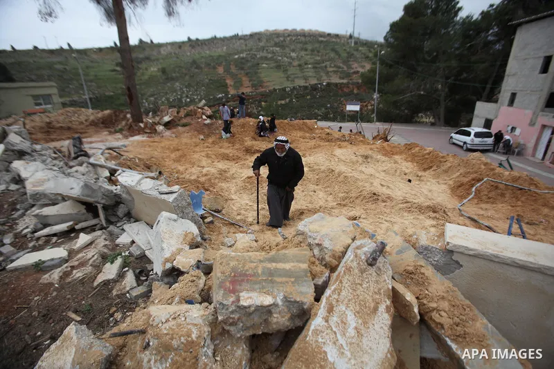 A Palestinian man inspects the damage to a children's garden after it was demolished by Israeli troops in the village of Za'tara near the West Bank city of Nablus, Tuesday, April 12, 2016. Israeli forces demolished the c...