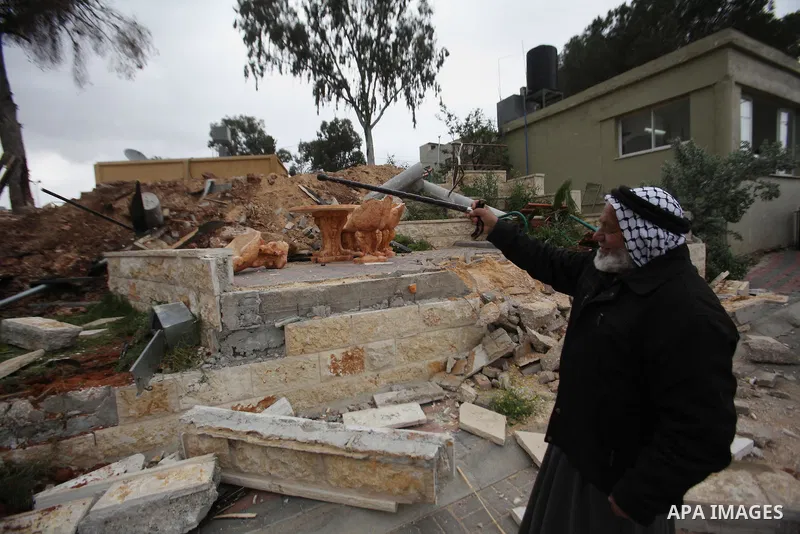 A Palestinian man inspects the damage to a children's garden after it was demolished by Israeli troops in the village of Za'tara near the West Bank city of Nablus, Tuesday, April 12, 2016. Israeli forces demolished the c...