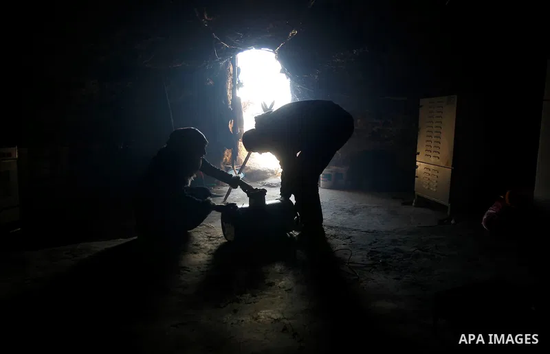 Palestinians of Hawamdeh family work inside a cave they live in, in West Bank village of Mufagara, south of Hebron on April 14, 2016. Photo by Wisam Hashlamoun