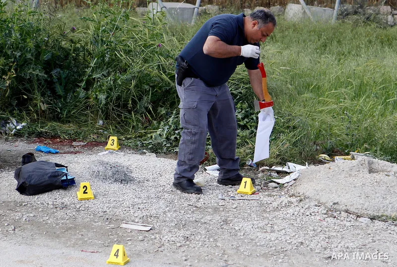 Israeli forces inspect the scene where a Palestinian, whom the Israeli military said attacked Israeli soldiers with an ax, was shot dead at the entrance of Arroub refugee camp, north of the West Bank city of Hebron April...