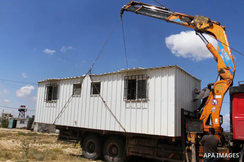Palestinian workers place containers as new sites for Palestinian security forces in front of the Gaza-Egypt border in Rafah in the southern Gaza Strip, on April 14, 2016. Senior Hamas leader Ismail Haniyeh confirmed tha...