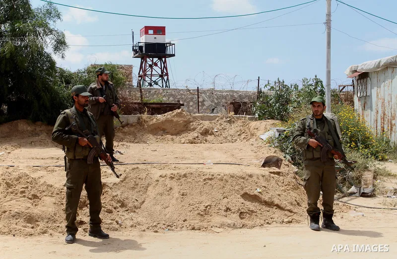 Members of Palestinian security forces stand guard in front of the Gaza-Egypt border in Rafah in the southern Gaza Strip, on April 14, 2016. Senior Hamas leader Ismail Haniyeh confirmed that Hamas spares no measures to p...