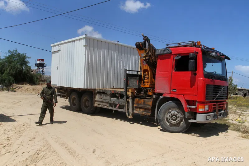 Palestinian workers place containers as new sites for Palestinian security forces in front of the Gaza-Egypt border in Rafah in the southern Gaza Strip, on April 14, 2016. Senior Hamas leader Ismail Haniyeh confirmed tha...