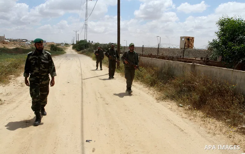 Members of Palestinian security forces stand guard in front of the Gaza-Egypt border in Rafah in the southern Gaza Strip, on April 14, 2016. Senior Hamas leader Ismail Haniyeh confirmed that Hamas spares no measures to p...