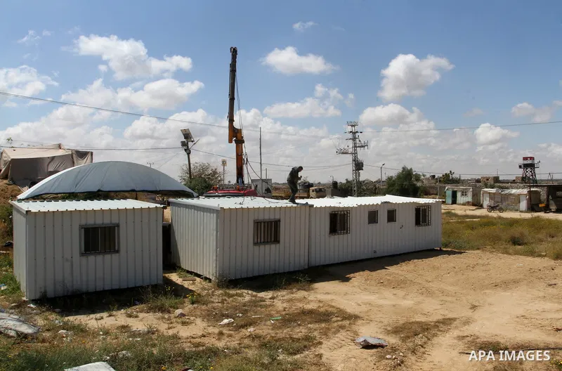 Palestinian workers place containers as new sites for Palestinian security forces in front of the Gaza-Egypt border in Rafah in the southern Gaza Strip, on April 14, 2016. Senior Hamas leader Ismail Haniyeh confirmed tha...
