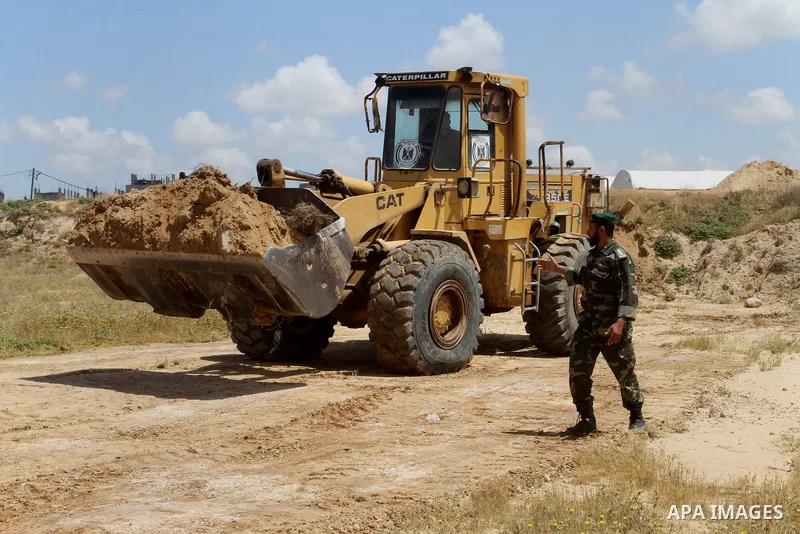 Palestinian bulldozer works in front of the Gaza-Egypt border in Rafah in the southern Gaza Strip, on April 14, 2016. Senior Hamas leader Ismail Haniyeh confirmed that Hamas spares no measures to protect the Gaza-Egypt b...
