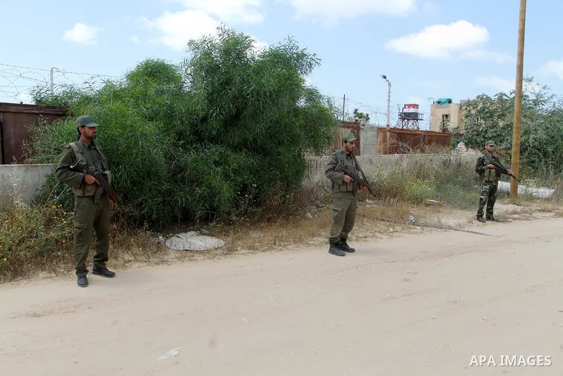 Members of Palestinian security forces stand guard in front of the Gaza-Egypt border in Rafah in the southern Gaza Strip, on April 14, 2016. Senior Hamas leader Ismail Haniyeh confirmed that Hamas spares no measures to p...