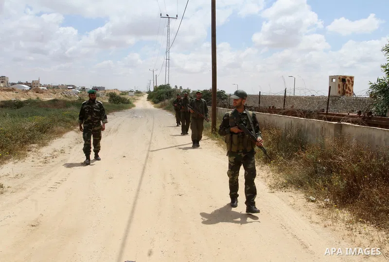 Members of Palestinian security forces stand guard in front of the Gaza-Egypt border in Rafah in the southern Gaza Strip, on April 14, 2016. Senior Hamas leader Ismail Haniyeh confirmed that Hamas spares no measures to p...