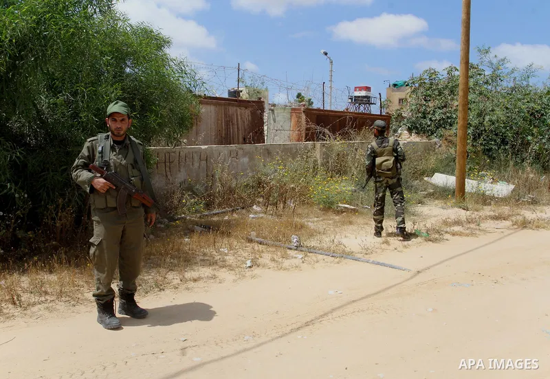 Members of Palestinian security forces stand guard in front of the Gaza-Egypt border in Rafah in the southern Gaza Strip, on April 14, 2016. Senior Hamas leader Ismail Haniyeh confirmed that Hamas spares no measures to p...