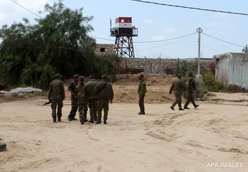 Members of Palestinian security forces stand guard in front of the Gaza-Egypt border in Rafah in the southern Gaza Strip, on April 14, 2016. Senior Hamas leader Ismail Haniyeh confirmed that Hamas spares no measures to p...