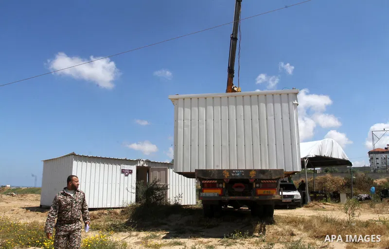 Palestinian workers place containers as new sites for Palestinian security forces in front of the Gaza-Egypt border in Rafah in the southern Gaza Strip, on April 14, 2016. Senior Hamas leader Ismail Haniyeh confirmed tha...