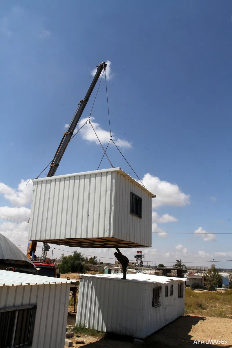Palestinian workers place containers as new sites for Palestinian security forces in front of the Gaza-Egypt border in Rafah in the southern Gaza Strip, on April 14, 2016. Senior Hamas leader Ismail Haniyeh confirmed tha...