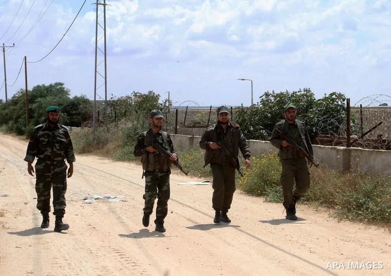 Members of Palestinian security forces stand guard in front of the Gaza-Egypt border in Rafah in the southern Gaza Strip, on April 14, 2016. Senior Hamas leader Ismail Haniyeh confirmed that Hamas spares no measures to p...