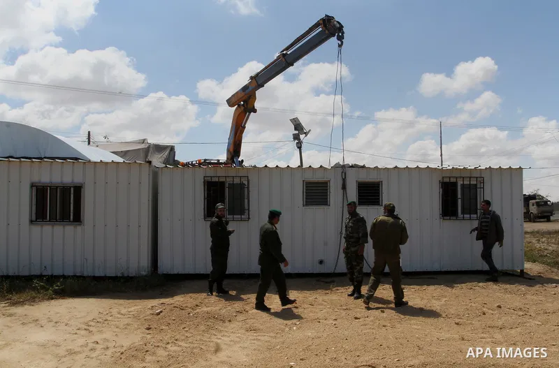 Palestinian workers place containers as new sites for Palestinian security forces in front of the Gaza-Egypt border in Rafah in the southern Gaza Strip, on April 14, 2016. Senior Hamas leader Ismail Haniyeh confirmed tha...