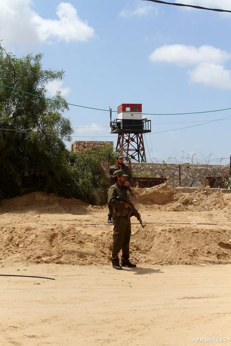 Members of Palestinian security forces stand guard in front of the Gaza-Egypt border in Rafah in the southern Gaza Strip, on April 14, 2016. Senior Hamas leader Ismail Haniyeh confirmed that Hamas spares no measures to p...