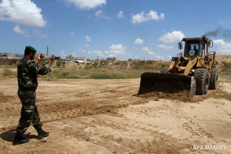 Palestinian bulldozer works in front of the Gaza-Egypt border in Rafah in the southern Gaza Strip, on April 14, 2016. Senior Hamas leader Ismail Haniyeh confirmed that Hamas spares no measures to protect the Gaza-Egypt b...