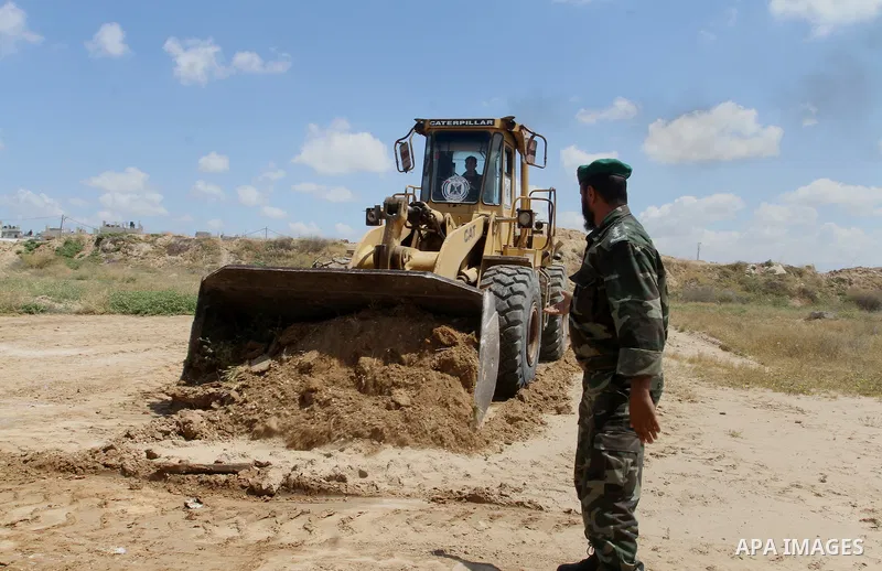 Palestinian bulldozer works in front of the Gaza-Egypt border in Rafah in the southern Gaza Strip, on April 14, 2016. Senior Hamas leader Ismail Haniyeh confirmed that Hamas spares no measures to protect the Gaza-Egypt b...