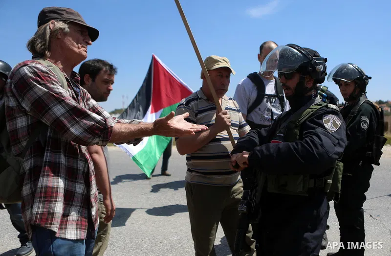 Palestinian protesters scuffle with an Israeli security forces during clashes following a march against Palestinian land confiscation on April 15, 2016 in the West Bank village of Nabi Saleh near Ramallah. Photo by Shadi...