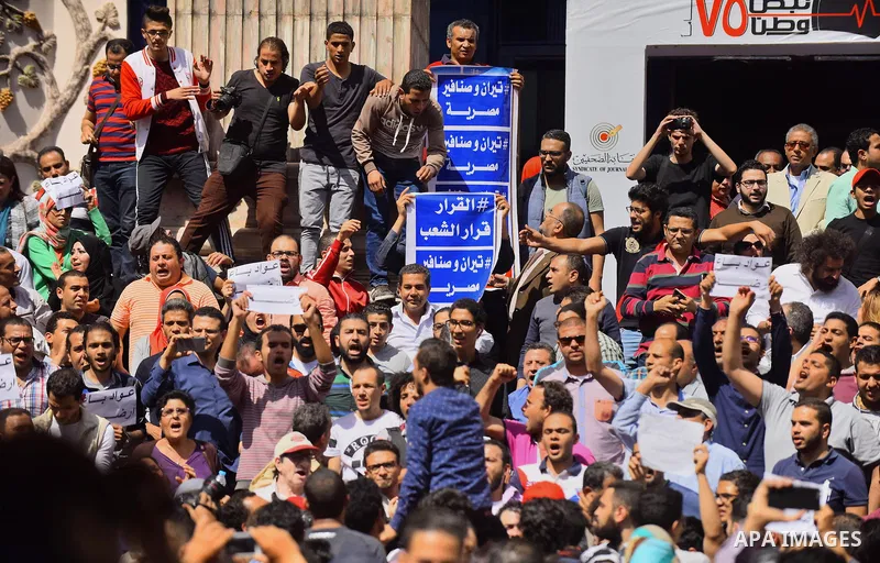 Egyptian activists shout slogans against President Abdel Fattah al-Sisi and his government, during a demonstration protesting the government's decision to transfer two Red Sea islands to Saudi Arabia, in front of the Pre...