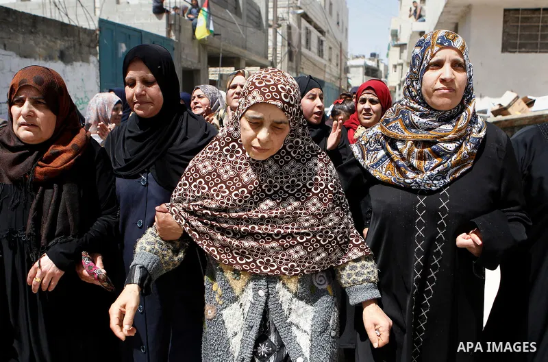 A sister of Palestinian Ibrahim al-Gharooz Baradeah, who was killed the day before in a reported attack with an axe on an Israeli soldier, mourns during his funeral on April 16, 2016 at al-Arroub Palestinian refugee camp...
