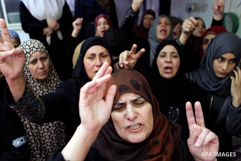 Relatives of Palestinian Ibrahim al-Gharooz Baradeah, who was killed the day before in a reported attack with an axe on an Israeli soldier, mourn during his funeral on April 16, 2016 at al-Arroub Palestinian refugee camp...