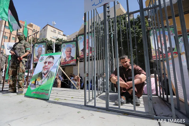 Members of the Ezzedine al-Qassam Brigades, the military wing of the Palestinian Islamist movement Hamas, stand next to mock jails during a rally marking Palestinian Prisoner Day in Gaza City on April 17, 2016. Photo by...