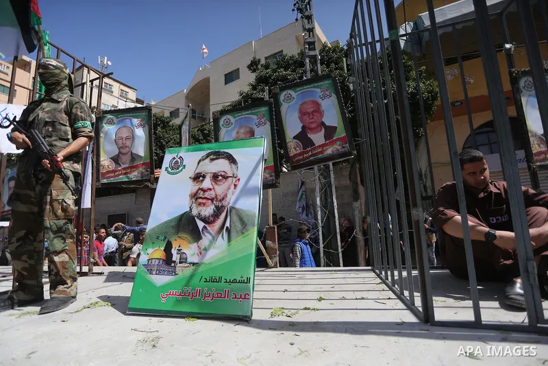 Members of the Ezzedine al-Qassam Brigades, the military wing of the Palestinian Islamist movement Hamas, stand next to mock jails during a rally marking Palestinian Prisoner Day in Gaza City on April 17, 2016. Photo by...