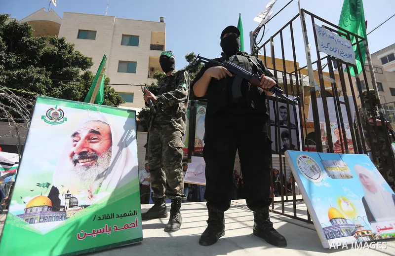 Members of the Ezzedine al-Qassam Brigades, the military wing of the Palestinian Islamist movement Hamas, stand next to mock jails during a rally marking Palestinian Prisoner Day in Gaza City on April 17, 2016. Photo by...